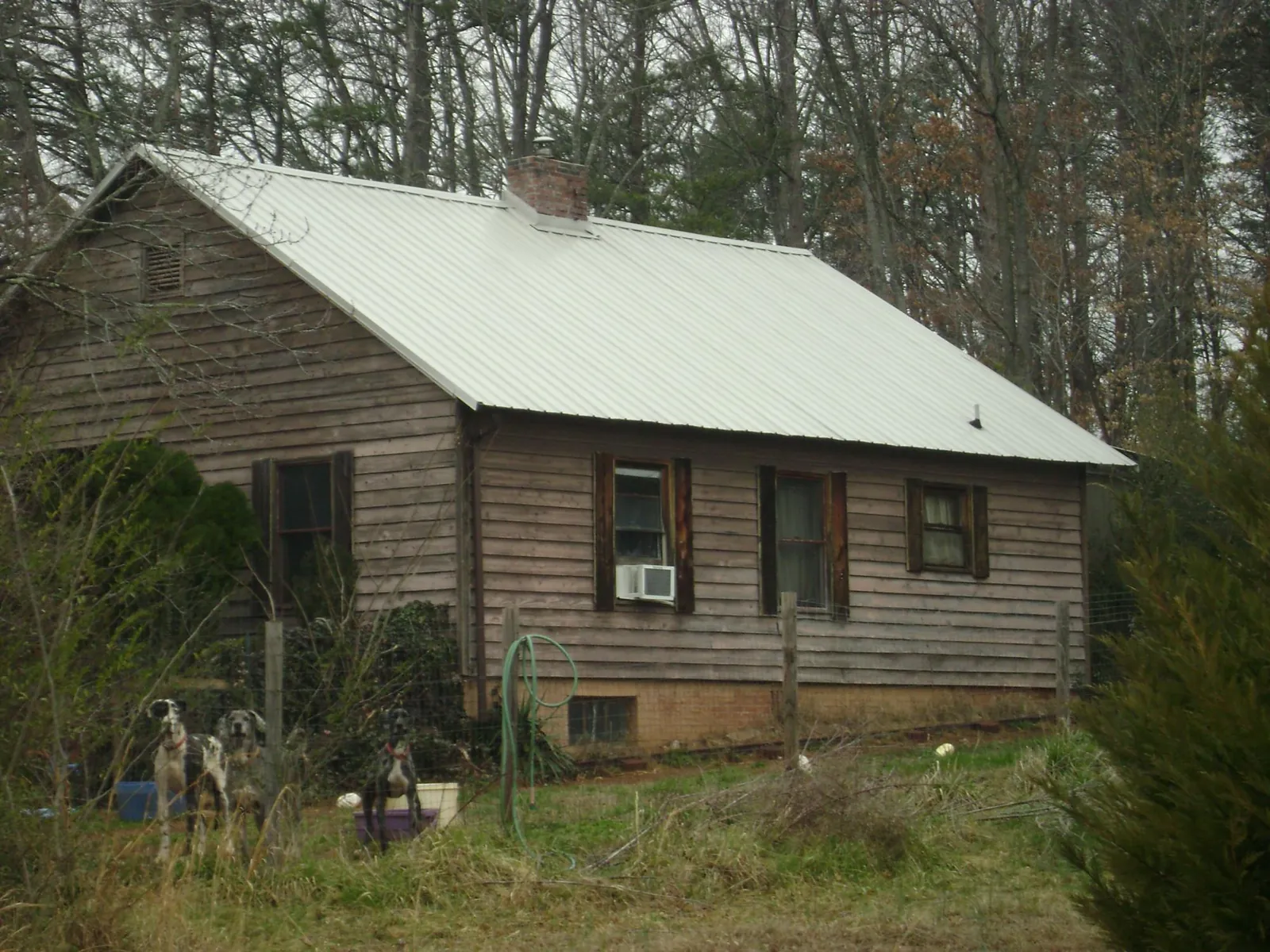 White metal roof on an old wood sided farmhouse, from a Metal Roof Installation job in Liverpool